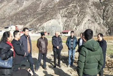 UN Volunteer Zeng Yunheng (China) during a field visit to local farms with agricultural experts in Zhouqu in January 2020