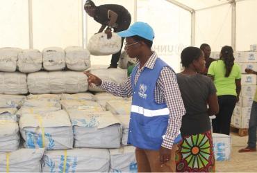 Kambarangwe inspects Core Relief Items in the Warehouse for distribution to refugees at Kenani transit centre in Nchelenge. Photo by UNHCR/Bruce Mulenga