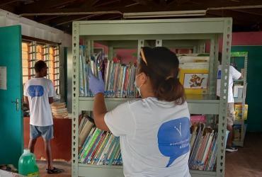 UN Volunteers cleaning St Christopher’s home library, where they conducted a book drive for disadvantaged children.