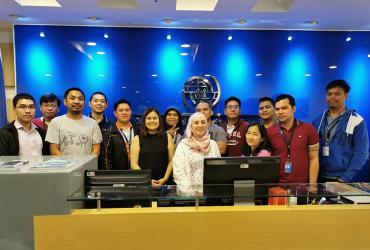 Maha (front row in hijab) poses with her Migrant application Team at the International Organization for Migration, Manila Administrative Center