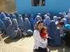 Atsuko Hirakawa in front of the Independent Election Commission in Parwan, where Afghan women wait to receive a Voter’s ID card to vote in the Presidential and Provincial Council elections.