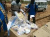 UN Volunteer Ferdinand Koanari (right) inspects electoral supplies delivered for the elections in Sebba, Burkina Faso.