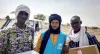 UN Volunteer UNHCR Oussamata Iba (centre), with two fellow refugees from the camp of Goudebou, Dori, Burkina Faso.