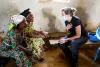 UN Volunteer Louise Gronmark, Political Affairs Officer and member of a multidisciplinary team from the Beni office, discusses the MONUSCO mandate with two women in the Eringeti area.