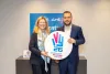 Louise Chamberlain, UNV Deputy Executive Coordinator, and Samed Ağırbaş, COP31 Climate High-Level Champion and President of the Zero Waste Foundation, hold the International Volunteer Day 2026 frame at UNV headquarters in Bonn.