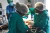 UN Volunteer Dr Sonia Bako (right) in action during surgery with her operating room team: Anaesthetist Cadidjatu Colubali (back) and Instrument Nurse Flamina Camala (left).