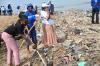 Fatoumata Toure (black t-shirt), UN University Volunteer Assistant for Protection Analysis and Reporting, during a beach cleaning activity in March 2023. The event was organized by the European Union, United Nations system and national authorities, on the occasion of World Water Day.