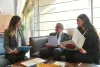National UN Volunteers Vicky Kendirjian (left) and Lara Riachi (right) review with Minister of State for Women Affairs, Mr Jean Oghassabian