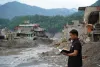 A UN Volunteer with UNFPA, Ashok Chaudhary, assesses flood-affected Nuwakot and Rasuwa Districts for emergency supply distribution.