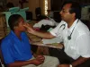 Former international UN Volunteer Doctor from India, Dr. Mukeshkumar Prajapati, photographed here while conducting a medical evaluation on an adolescent in Trinidad and Tobago in 2005.