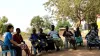 Kei Tanaka, UN Volunteer with UNHCR, meets rice farmers at a refugee settlement in Uganda. 