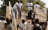 Gideon Sackitey (right) helps colleagues to offload mattresses - part of the items they donated to the children's ward at Bor Town Hospital  in South Sudan - from a truck.