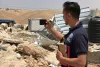 Abdelrahman Salayma, national UN Volunteer with OCHA in the State of Palestine, assessing a demolition site in Hebron. 