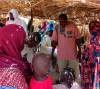 Dr. Mahamadou Nouri Kassimoune Tago, UN Volunteer Specialist, conducts a routine vaccination monitoring session at a WHO vaccination site. 