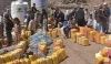 Families line up for water distribution in Yemen.