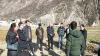 UN Volunteer Zeng Yunheng (China) during a field visit to local farms with agricultural experts in Zhouqu in January 2020