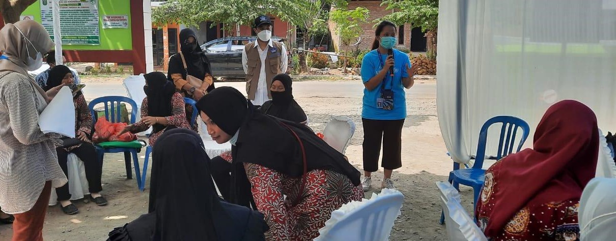 Elda (in blue T-shirt) briefs health cadres about world immunization week in Takalar District, South Sulawesi, Indonesia.